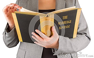 Woman reading a marriage almanac Stock Photo