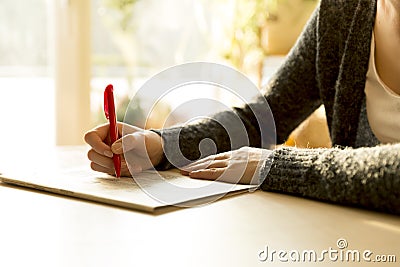 Woman reading newspaper and searching advertisements for emplyment, job, real estate, car sale information Stock Photo