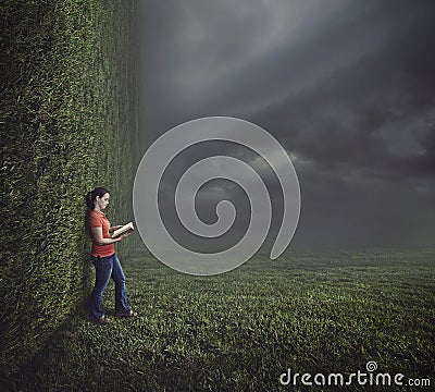 Woman reading on surreal landscape. Stock Photo