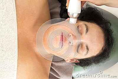 Woman receives diamond peeling at beauty clinic Stock Photo