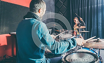 Woman receiving drum lessons from her music teacher Stock Photo