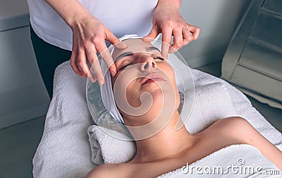 Woman receiving facial treatment on clinical center Stock Photo