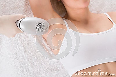 Woman Receiving Laser Epilation Treatment In Spa Stock Photo