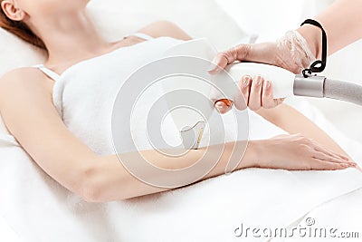 Woman receiving laser skin care on hand Stock Photo