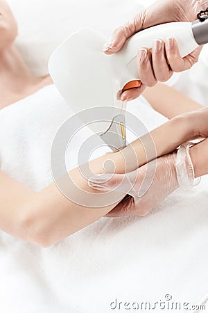 Woman receiving laser skin care on hand Stock Photo