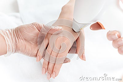 Woman receiving laser skin care on hand Stock Photo