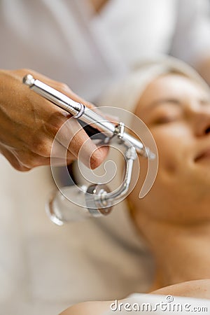 Woman receiving oxygen mesotherapy on her face, Stock Photo