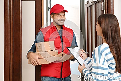 Woman receiving parcels from delivery service courier Stock Photo