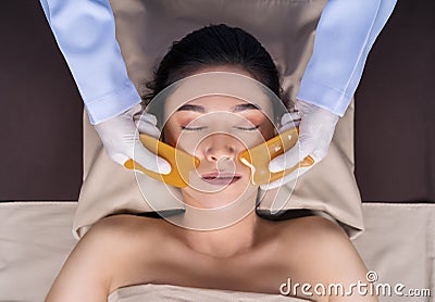 Woman receiving traditional guasa face therapy Stock Photo