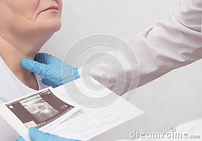 A woman is on reception at the endocrinologist, the doctor looks at the results of an ultrasound scan of the thyroid gland, close- Stock Photo