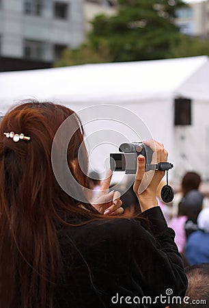 Woman recording an event Stock Photo