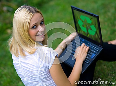 Woman with recycle logo on laptop Stock Photo