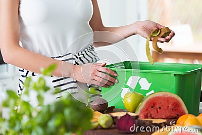 Woman composting organic kitchen waste Stock Photo
