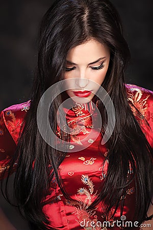 Woman in red Cheongsam on dark background Stock Photo