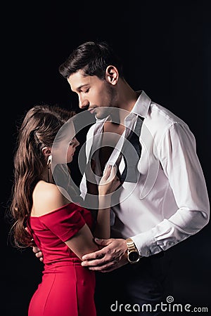 woman in red dress undressing man shirt isolated Stock Photo