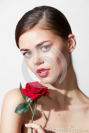 Woman with red flower Bare shoulders pure luxury leather red lips Stock Photo