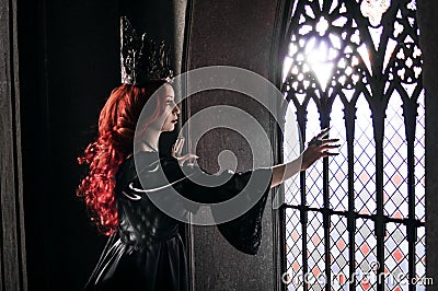 Woman with red hair in ancient castle Stock Photo