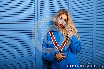 Woman with red lips in a blue fashionable sweatshirt Stock Photo