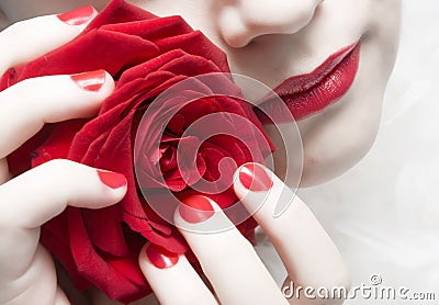 Woman with red lips, nails and rose Stock Photo