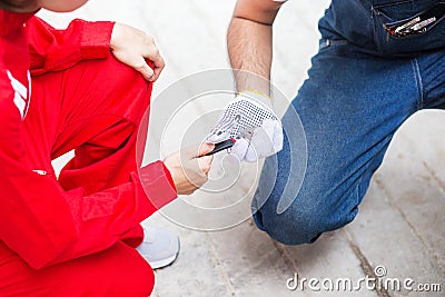 Woman in red uniform give a instrument to mechanical engineer in Stock Photo