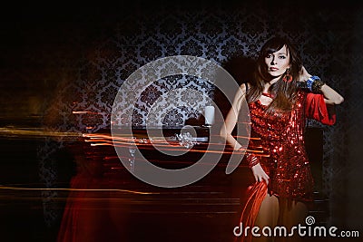 Woman in red waving dress in interior Stock Photo