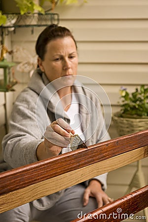 Woman Refinishing Piece of Furniture Stock Photo