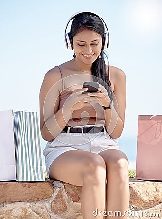 Woman relax after shopping, smartphone and headphones, listening to music outdoor with retail therapy and rest. Happy Stock Photo