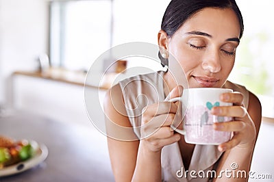 Woman, relax and smell coffee on kitchen or morning, enjoying and holding mug or cup. Female person, drinking tea or Stock Photo