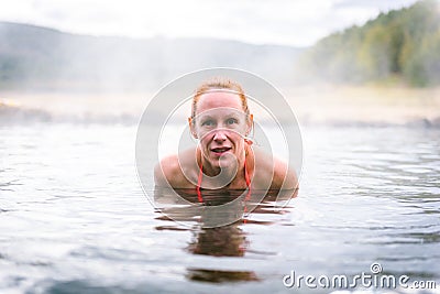 Woman relaxes and enjoys natural hot thermal water roman spa Stock Photo