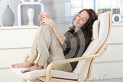 Woman relaxing in armchair Stock Photo