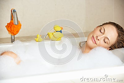 Woman Relaxing In Bubble Filled Bath Stock Photo