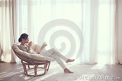 Woman relaxing in chair Stock Photo