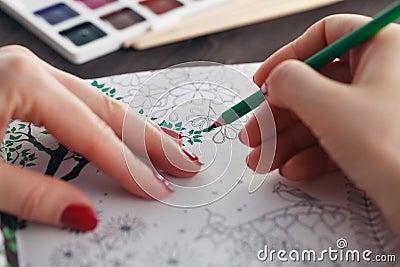 Woman relaxing while do painting adult coloring book Stock Photo