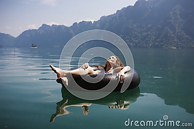 Woman relaxing on a floating ring Stock Photo