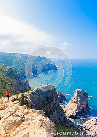 View of Woman relaxing on rocky cliff Cabo da Roca, Portugal Editorial Stock Photo