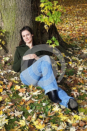 Woman relaxing under a tree Stock Photo