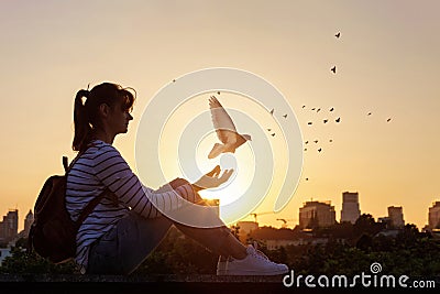 Woman releases a dove and prays Stock Photo