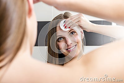 Woman removing makeup Stock Photo