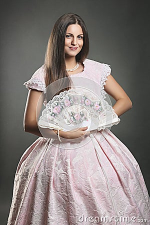 Woman with renaissance dress and floral fan Stock Photo