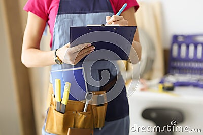 Woman repairman writing paper on clipboard closeup Stock Photo