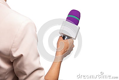 A woman reporter is holding a microphone. The Stock Photo