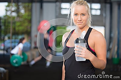 Woman rest and drinking water at fitness gym Stock Photo