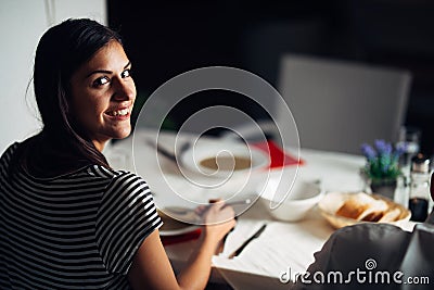 Woman in restaurant eating vegetarian vegan cream soup.Gluten free and diet food.Female eating bone broth based soup.Nutrition Stock Photo