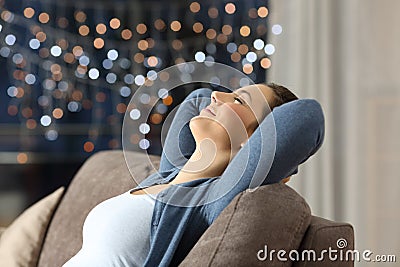 Woman resting on a couch in the night at home Stock Photo