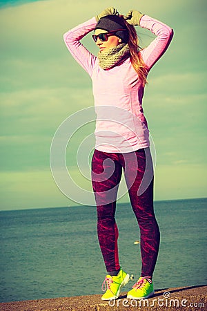 Woman resting after doing sports outdoors on cold day Stock Photo