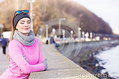 Woman resting after doing sports outdoors on cold day Stock Photo