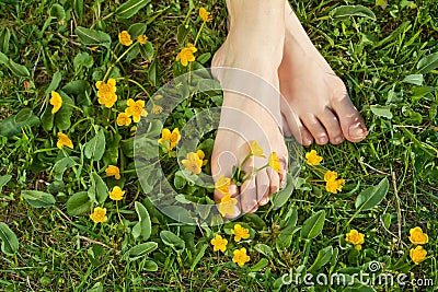 Woman resting her feet in the grass Stock Photo