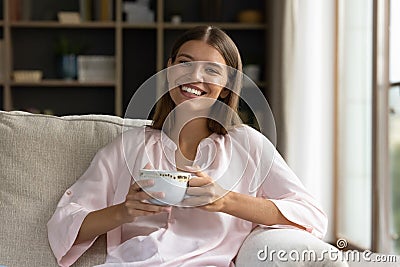 Woman resting on holds tea cup smile look at camera Stock Photo