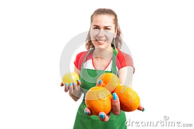 Woman retail of supermarket worker offering tangerines Stock Photo