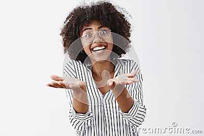 Woman retelling exciting story with emotive gestures. Thrilled and amazed african-american talkative woman with curly Stock Photo